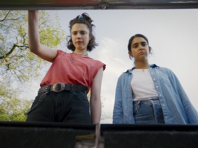 Margaret Qualley and Geraldine Viswanathan eye the MacGuffin in the trunk.