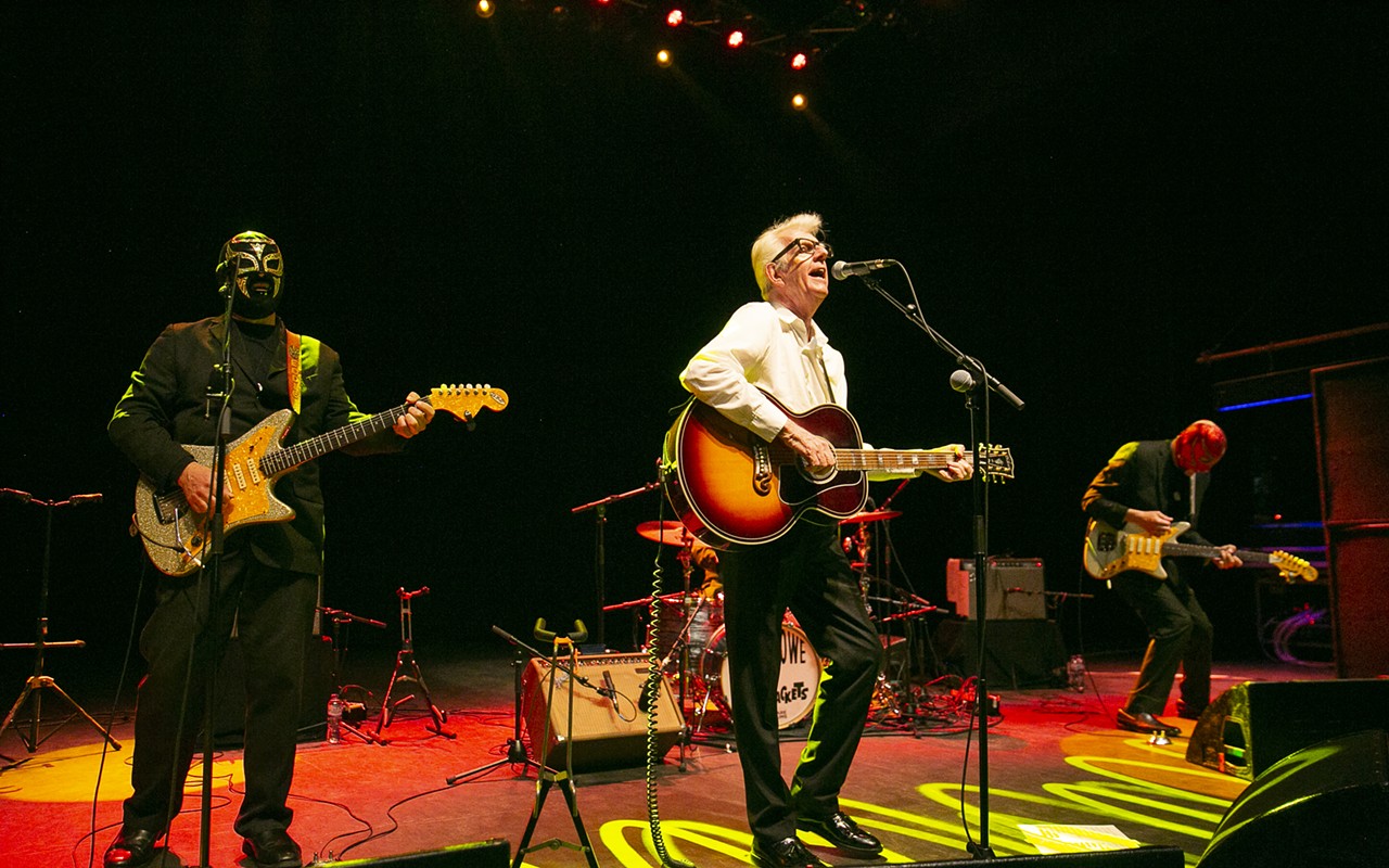 Nick Lowe (center) performs with Los Straitjackets.