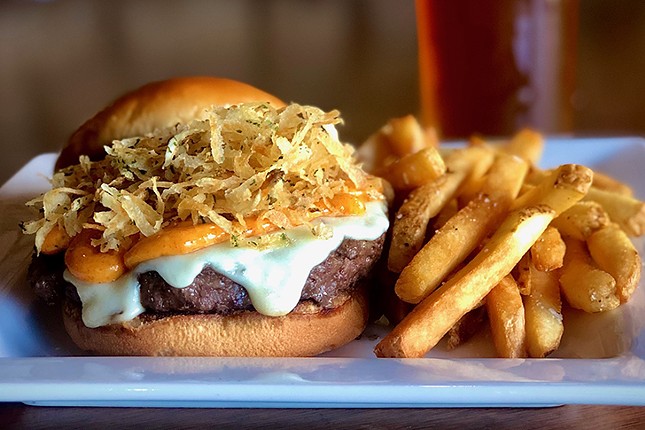 deSha's American Tavern
    A Ducking Good Burger: Ground beef, fontina cheese, roasted tomato-garlic aioli, topped with shredded potatoes tossed in duck fat and served on a brioche bun 
    Photo: Provided