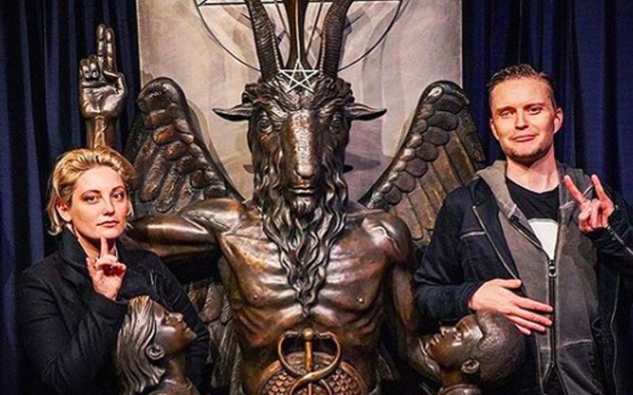 Temple of Satan co-founder Lucien Greaves (right) flashes the horns with a friend.