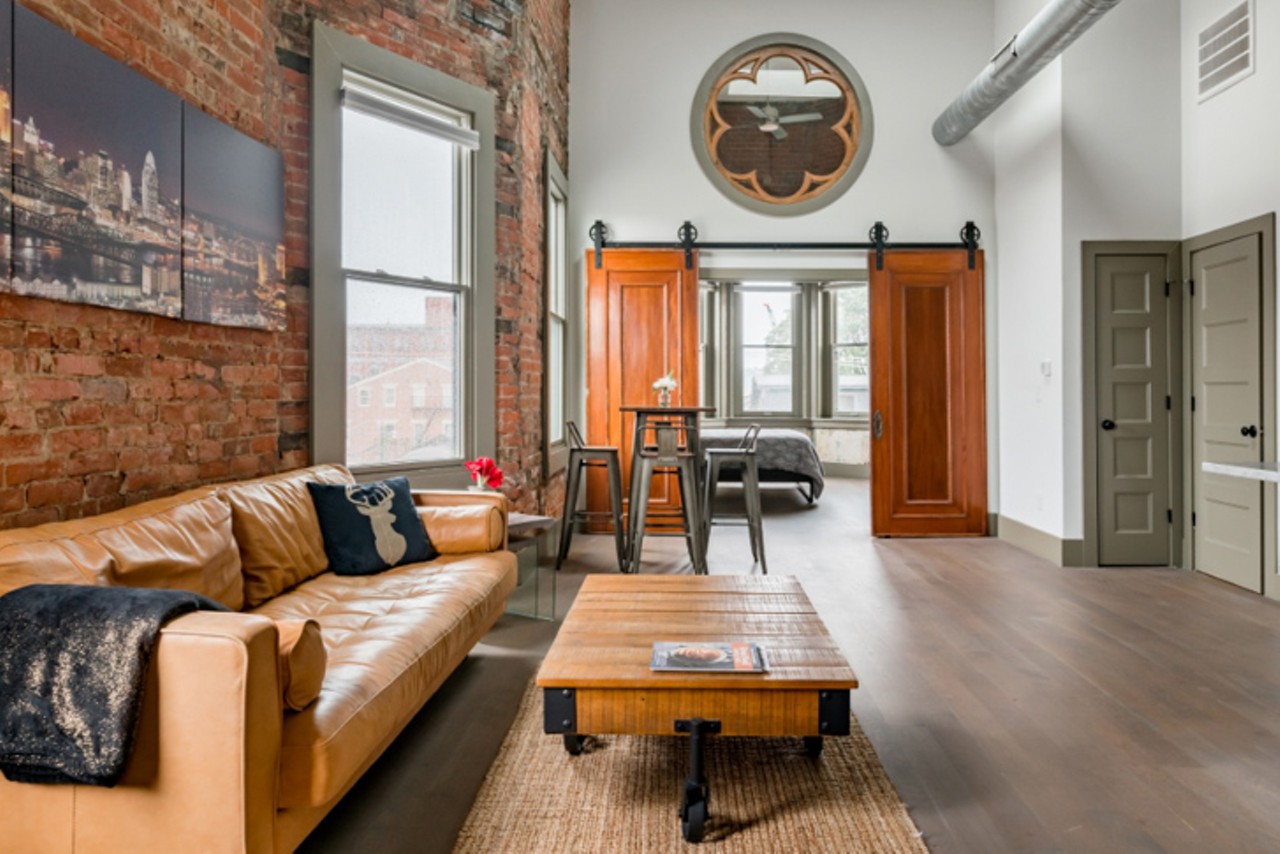 Tour Cincinnati from a Stunning Loft Condo
Over-the-Rhine
Entire Loft | Starting at $99/night | Host 4 Guests
"Walk through a 1890s building renovated to maintain its historic integrity while still adding modern elements. The industrial-chic aesthetic features strand bamboo flooring with exposed masonry, bay windows, and decorative detailing."
Photo via Airbnb.com