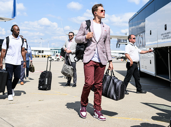 Cincinnati Bengals quarterback Joe Burrow wears a plaid jacket and burgundy trousers before the game against the Dallas Cowboys on Sept. 18, 2022.