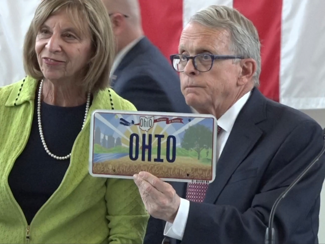 Ohio Gov. Mike DeWine reveals Ohio's new license plate design in October 2021.