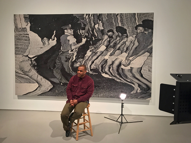 Noel Anderson in front of his monumental tapestry “die Leitung” in "Blak Origin Moment."