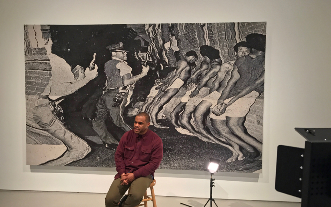 Noel Anderson in front of his monumental tapestry “die Leitung” in "Blak Origin Moment."