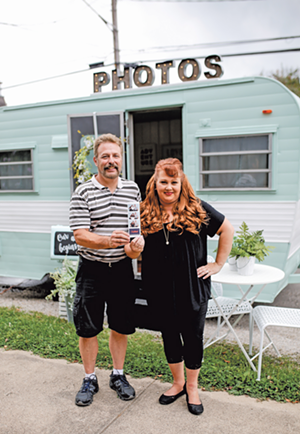 Jeff and Lori Lewis show off photo booth pics outside their mint-green camper called Julep - Photo: Hailey Bollinger