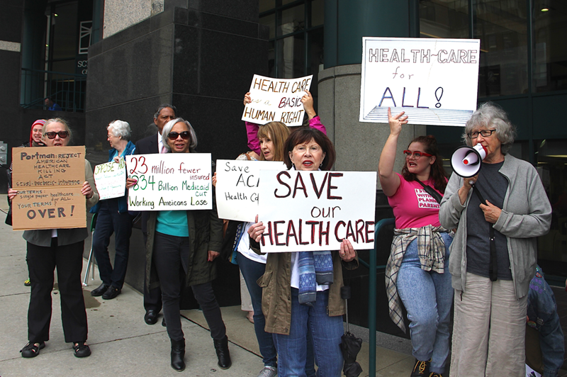 Protesters gather outside U.S. Sen. Rob Portman's downtown Cincinnati office to decry GOP efforts to repeal and replace the Affordable Care Act. - Nick Swartsell