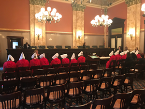 Women dressed as characters from the Handmaid's Tale at an Ohio Senate committee meeting on SB145 - NARAL Pro Choice Ohio Twitter account
