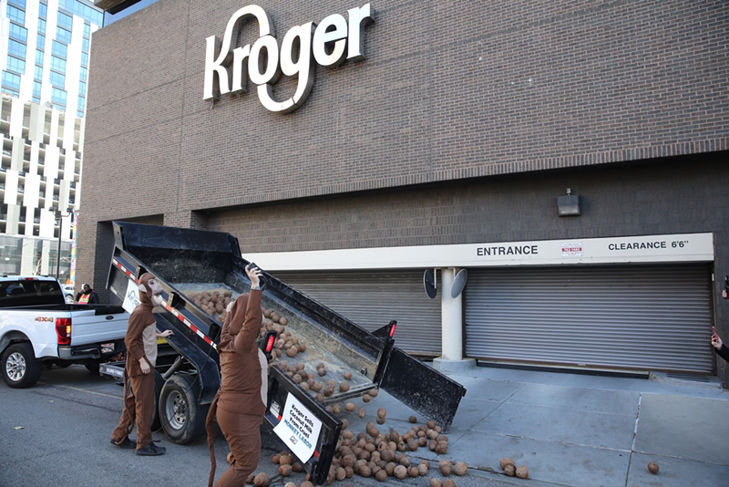 PETA supporters dropping humanely picked coconuts in front of Kroger's downtown HQ last month to protest their involvement with coconut milk brands that use monkey slave labor - Photo: PETA