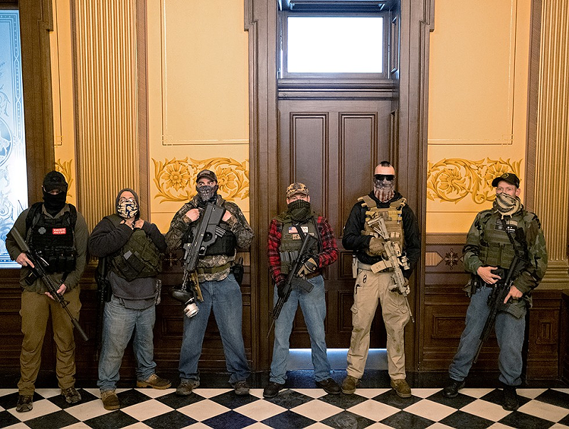 Pete Musico (right), one of the men who was charged Oct. 8 for his involvement in a plot to kidnap Michigan Gov. Gretchen Whitmer, stands in front of the Governors office after protesters occupied the state capitol building on April 30, 2020. - Photo: REUTERS/Seth Herald