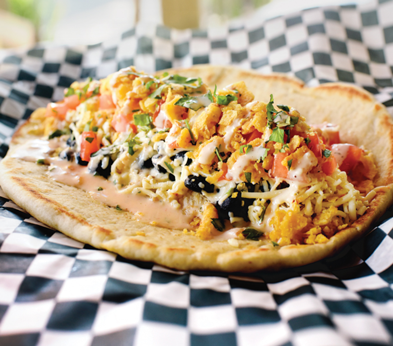 The Nelson Mandela features rotisserie chicken, fresh toppings and housemade sauce on grilled pita.