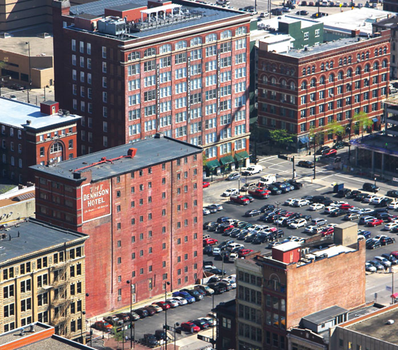 The Dennison Hotel, constructed in 1892, today is surrounded by surface parking lots once occupied by similar buildings.