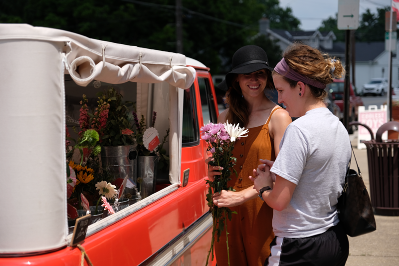 Megan Moore helping a customer arrange a bouquet. - Billy Keeney