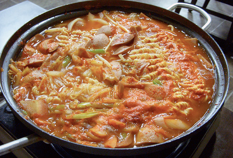 Budae Jjigae, or Army Stew, is made with Spam, ramen noodles, kimchi and other ingredients like baked beans or hot dogs.