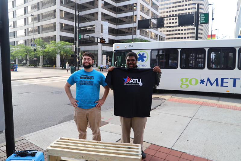 Mark Samaan and Cam Hardy of the Better Bus Coalition with a bench the group will soon place at a bus stop currently without seating. - Nick Swartsell