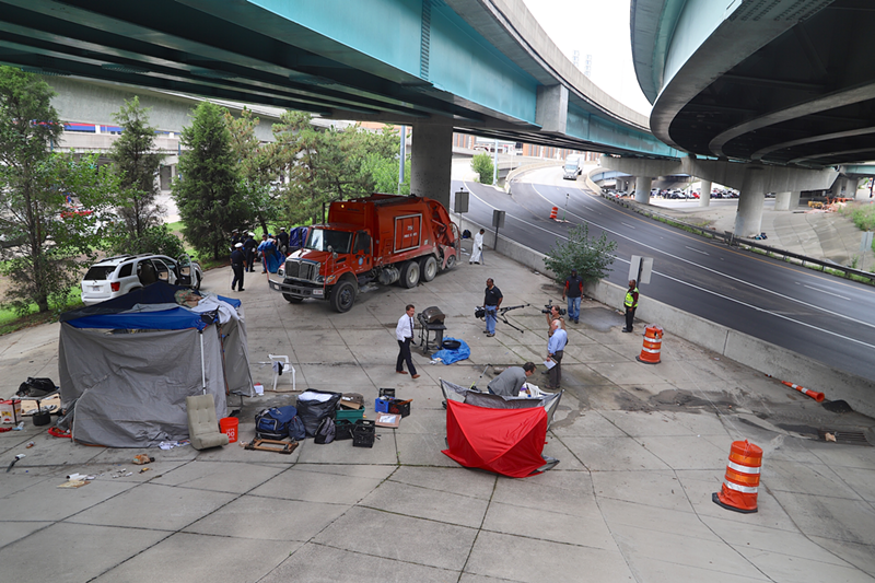 City of Cincinnati workers remove a tent city in downtown this summer - Nick Swartsell