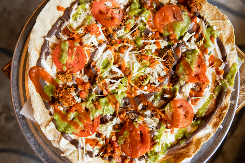 A tlayuda — imagine a love child between a Mexican pizza and a giant loaded nacho - Photo: Hailey Bollinger