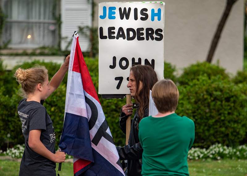 A man carrying an anti-Semitic sign joined a protest outside the Bexley home of then-Ohio Department of Health Director Dr. Amy Acton. Other protesters brought guns. - PHOTO: COURTESY OF KATIE FORBES