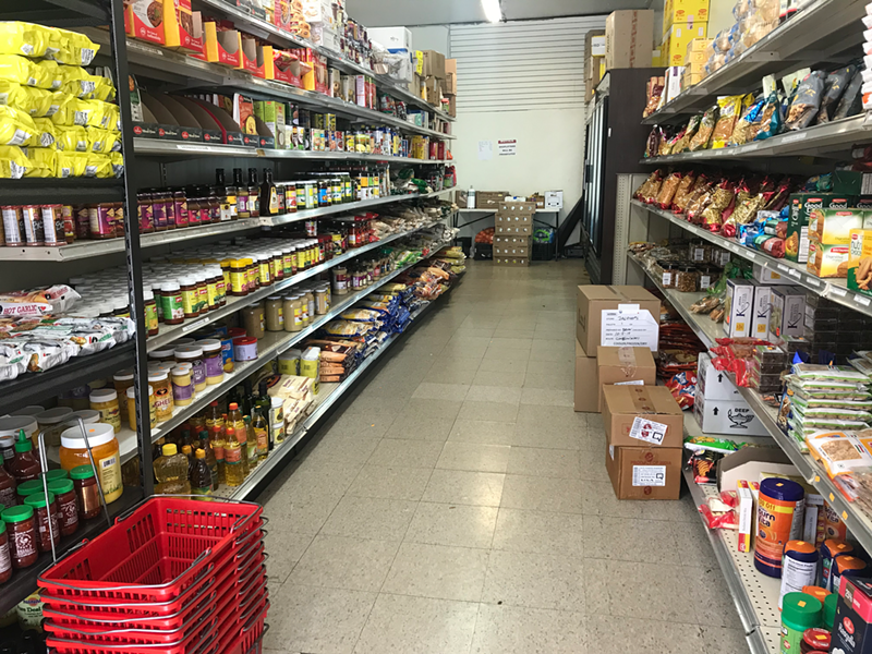 Cooking sauces, ghee, canned goods and more on the shelves at Jagdeep's Indian Grocery in Clifton - Photo: Lauren Moretto