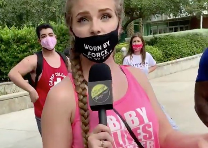 Kaitlin Marie Bennett in a pink tank top that says "Baby Lives Matter" and a mask that says "Worn by force not by fear." - Photo: @shivorsomething