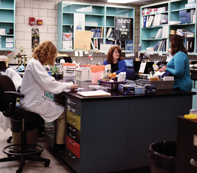 Employees share a desk inside the DNA lab.