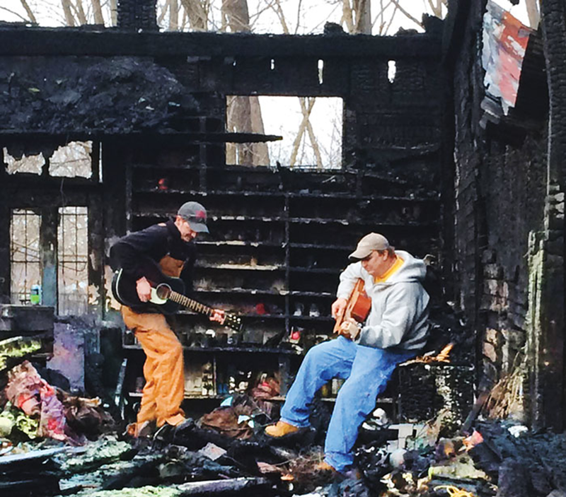 Kyle Smith (left) and Steve Lawrence in the ashes of the post-fire Rabbit Hash General Store.