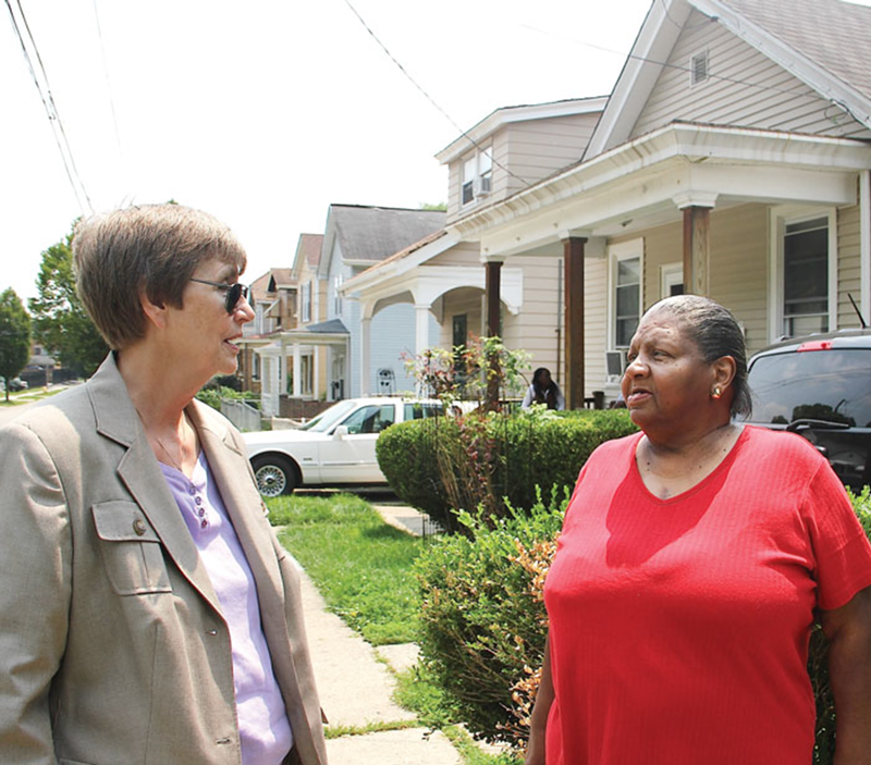 Sister Barbara Busch of Working in Neighborhoods (left) discusses houses the group has renovated in South Cumminsville with Marilyn Evans of Communities United for Action.