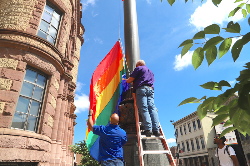 City workers raise the pride flag outside of Cincinnati City Hall. The Queen City is one of about two dozen throughout Ohio with its own municipal anti-discrimination laws for sexual orientation. The state doesn't have those laws — yet. - Photo: Nick Swartsell