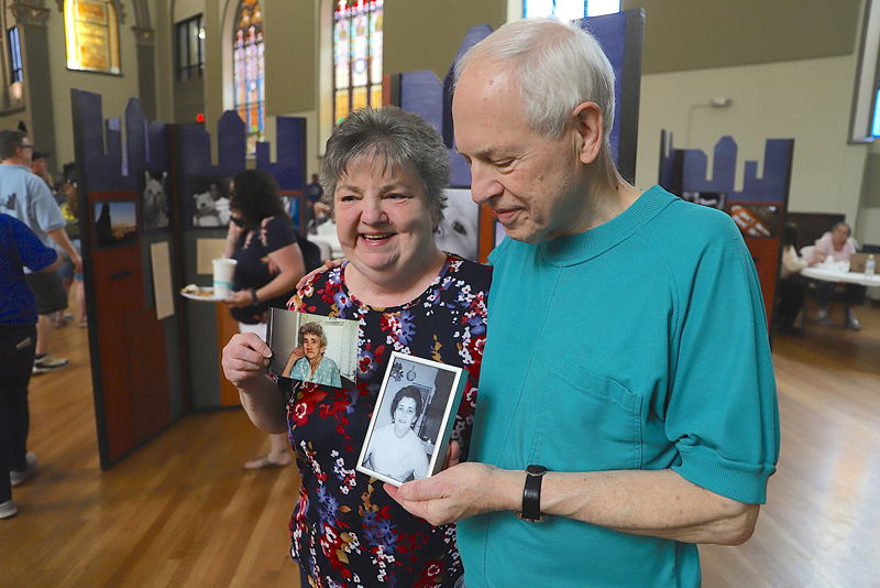 Sondra Saylor and Michael Maloney pose with pictures of Sondra's mother Effie Saylor, a matriarch of Lower Price Hill's Appalachian community for decades. - Nick Swartsell