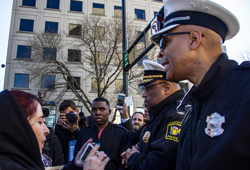CPD Specialist Scotty Johnson speaks to demonstrators during a march protesting the Ray Tensing mistrial. - Nick Swartsell