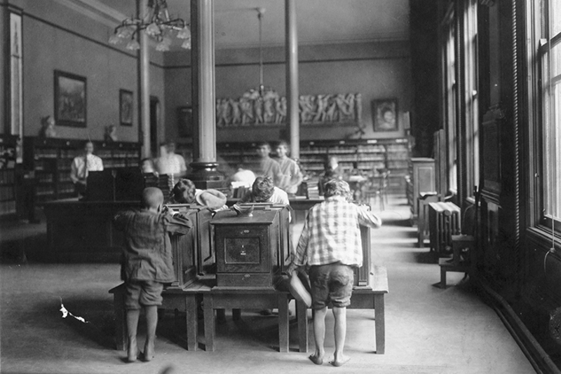Kids using the stereopticon, which is a slide projector also known as a "magic lantern." The device is made up of two lenses, typically one layered over the other. - Courtesy of The Public Library of Cincinnati and Hamilton County