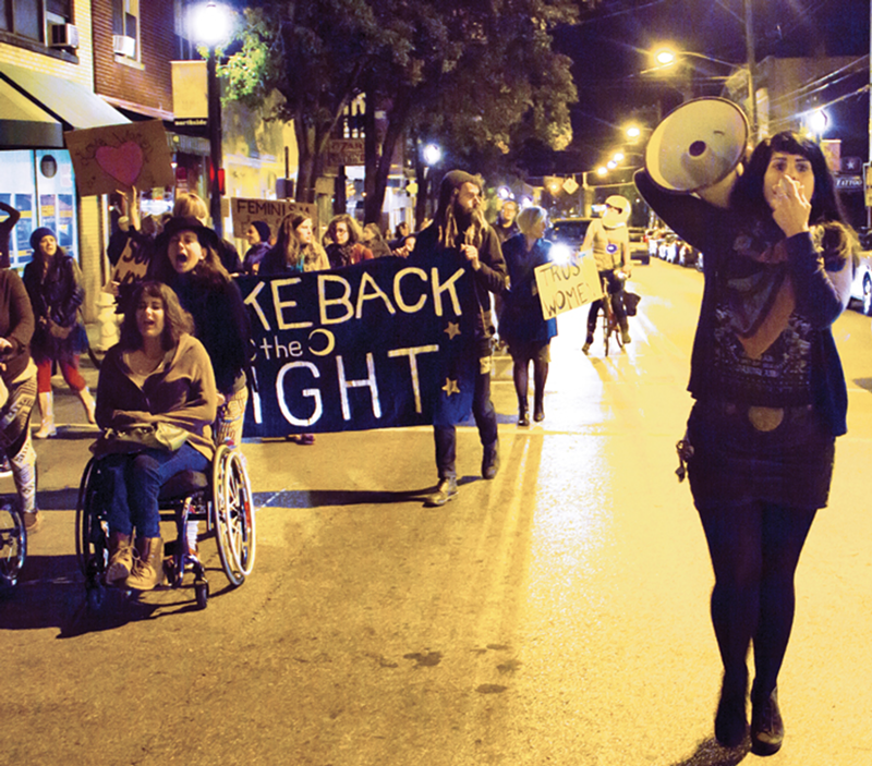 Cincinnati Radical Feminist Collective organizer Jen Mendoza (right) leads an Oct. 11 march in Northside.