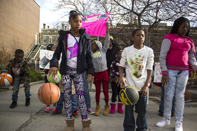 Ten-year-old Ishawn Walker (second from right) and other students on March 30 protest a plan to remove basketball courts next to Rothenberg School.