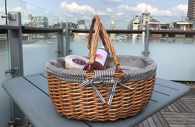 The Feast by Metropole picnic basket is filled withspecial snack pack featuring a bottle of screw-top rosé, cheese, charcuterie, hummus, tabbouleh, crackers and a melon and berry salad. - Photo: Provided by Metropole