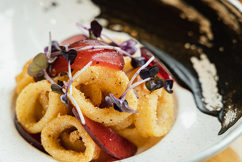 Cornmeal-crusted calamari with pickled plums and radish sprouts - Photo: Hailey Bollinger