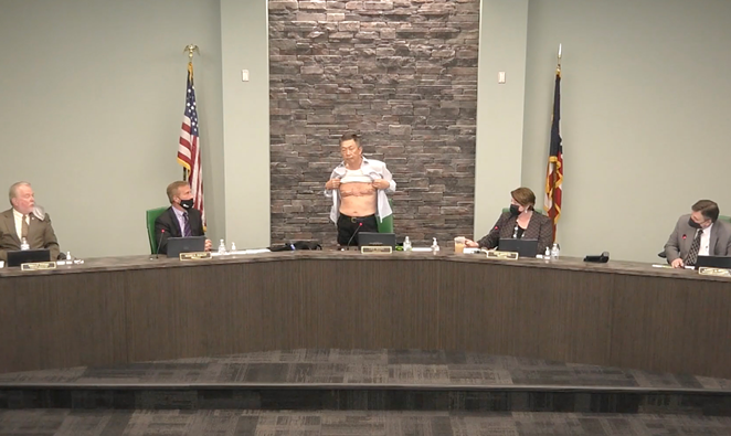 Lee Wong, chairman of the West Chester Township Board of Trustees, removed his shirt during a March 23 meeting to repudiate the anti-Asian sentiment and violence that’s been rising nationwide. - Photo: Still image from Vimeo of West Chester's Board of Trustees meeting
