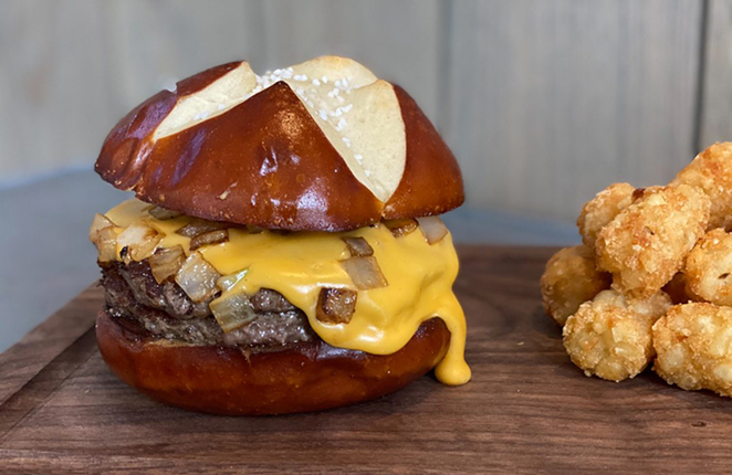 Nation Kitchen & Bar's Beer Cheese Burger: Two beef patties, West Side Brewing Common Ale beer cheese, and sautéed onions, on a pretzel bun. - PHOTO: NATION KITCHEN & BAR