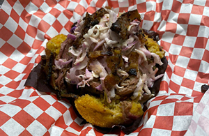 Pork Grenade: a sweet cornbread muffin topped with maple butter, pulled pork, homemade coleslaw, peppered bacon and barbecue sauce. - PHOTO: FACEBOOK.COM/MCKSCHICKS