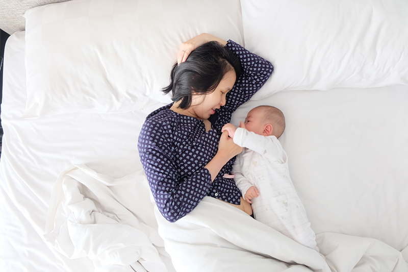 Women heads of household and single moms are benefitting from lower healthcare premiums. - Photo: Kevin Liang, Unsplash