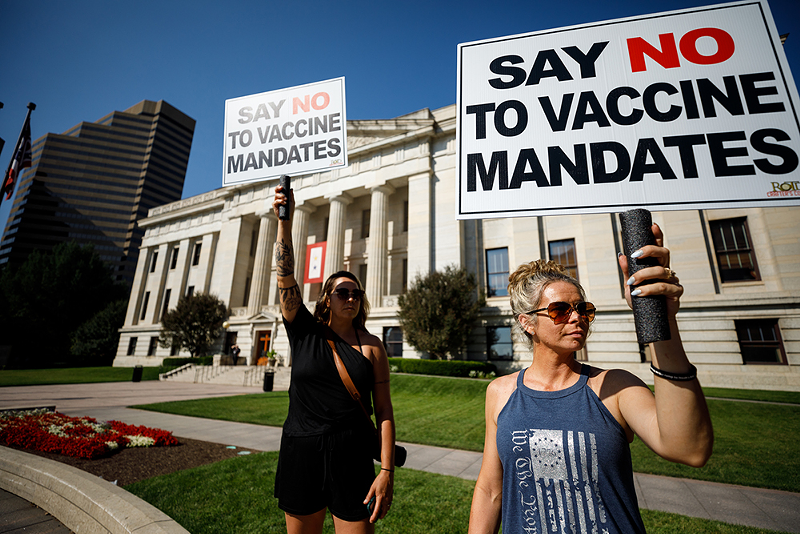 Two women protest vaccine mandates Aug. 24 outside a hearing at the Ohio Statehouse on legislation that would outlaw the practice from employers. - Photo: Graham Stokes