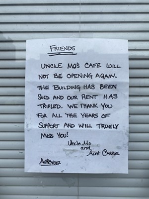 The sign hanging in the window of Uncle Mo's. - Photo: CityBeat Staff