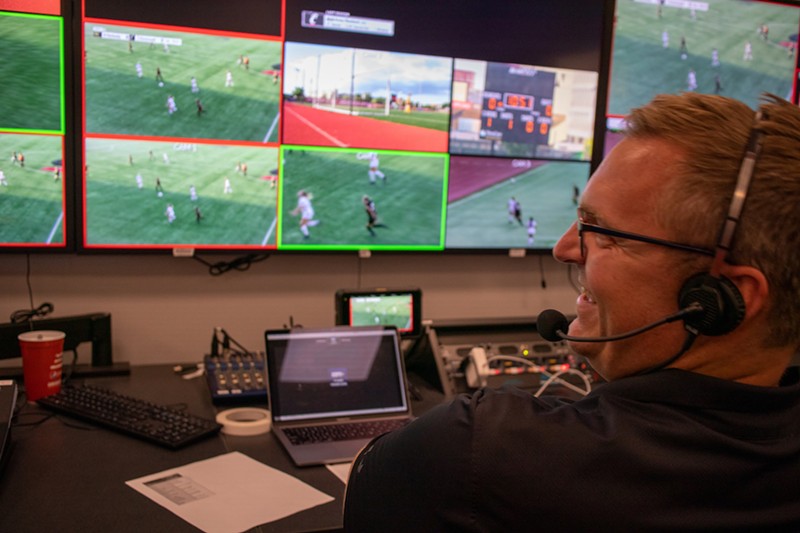 Joe Brackman, assistant professor of multi-camera productions at the University of Cincinnati, directs live sports productions from the broadcast control room in Nippert West Pavilion - Photo: Michael Asher