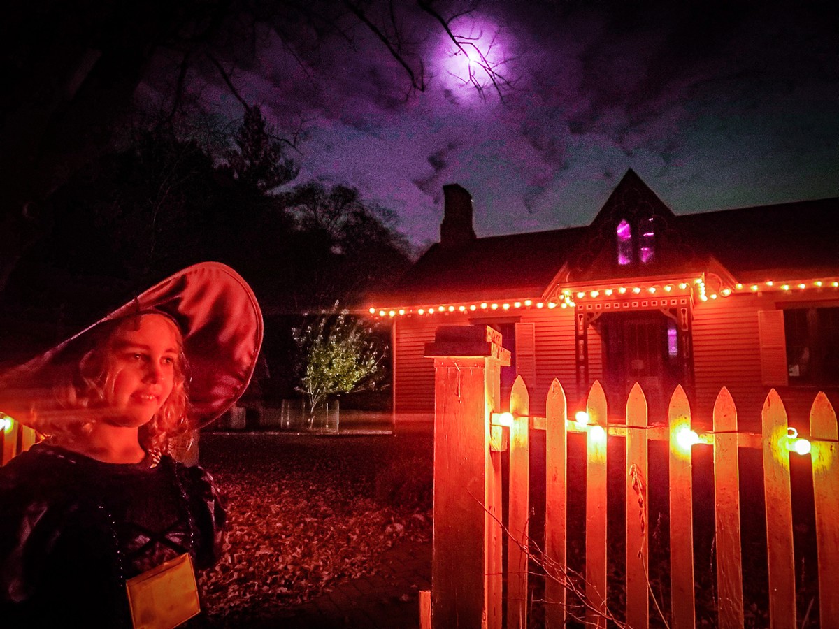 Little witch, Ella Jewell, trick-or-treating through the Haunted Village.