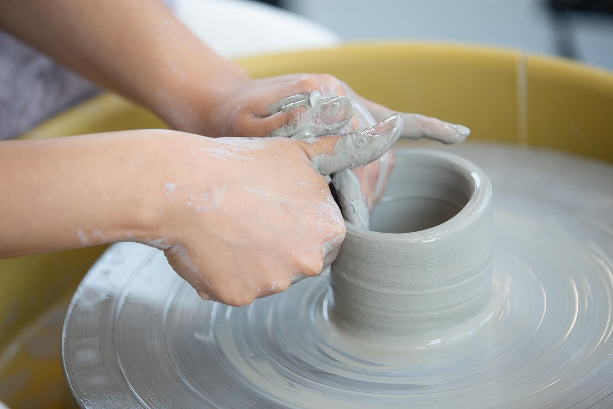 Student in wheel throwing ceramics workshop.