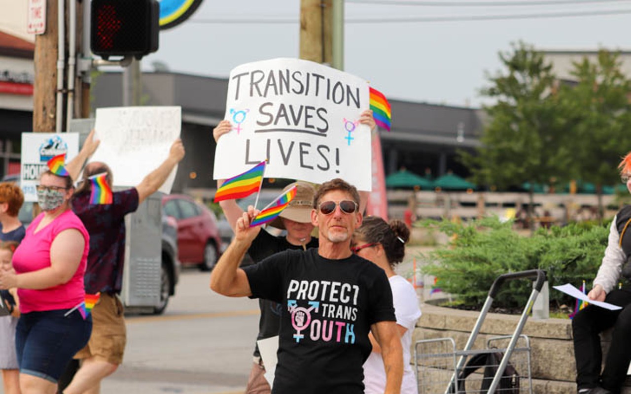 A demonstrator marches at a rally for LGBTQ+ people in Cincinnati.