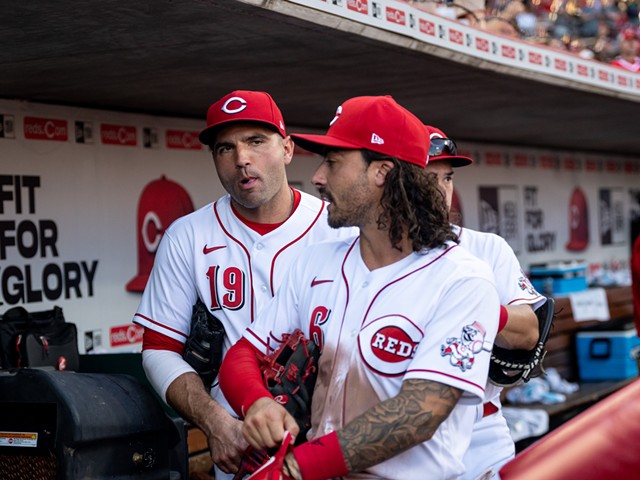 The Cincinnati Reds' Joey Votto (left) and Jonathan India head to the field during a game against the Miami Marlins on July 27, 2022.