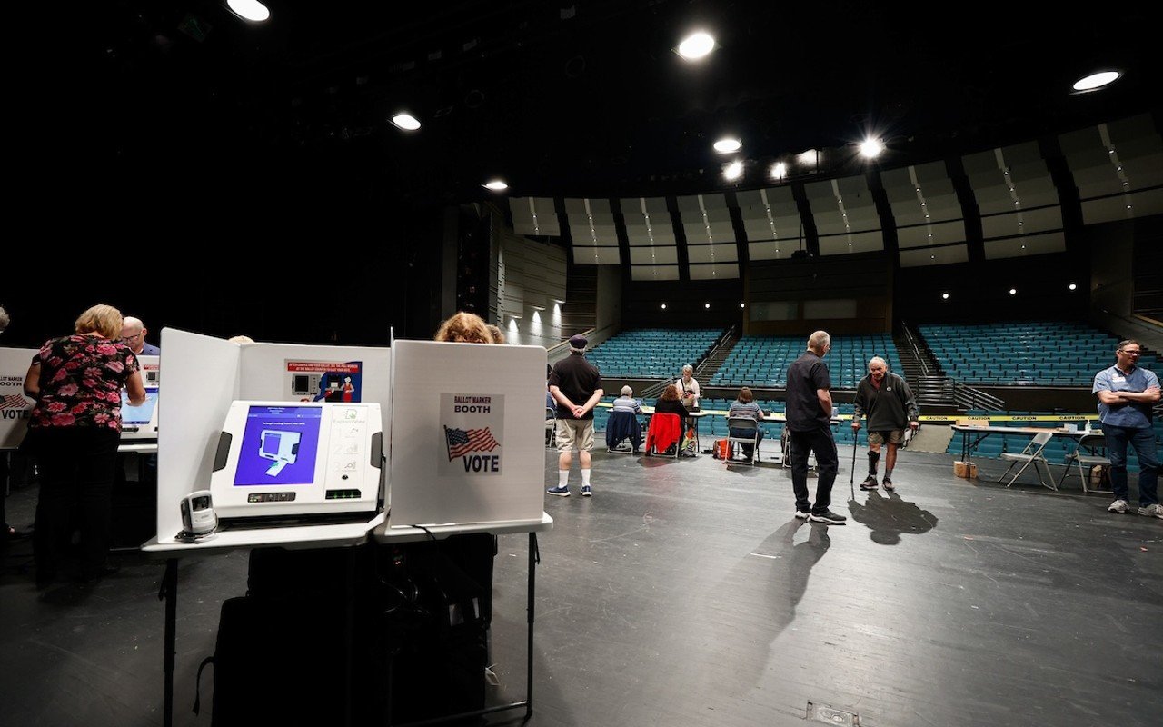 COLUMBUS, OH — MAY 03: Steve Fuller (center right) walks with a cane to vote on the auditorium stage that serves as the voting location during the Ohio primary election, May 3, 2022, at the Worthington Kilbourne High School, Columbus, Ohio.