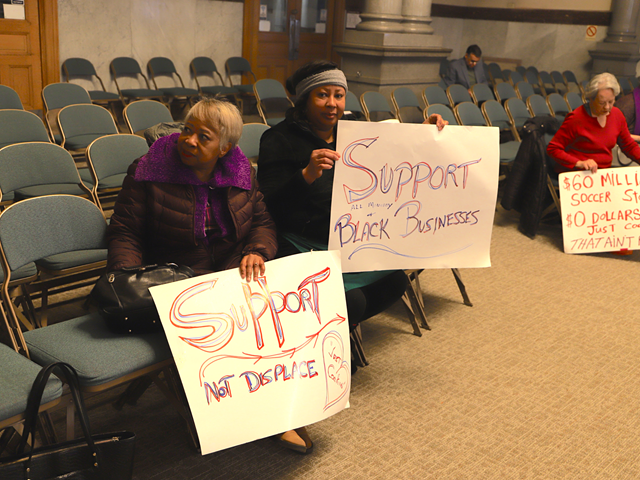 Monica Williams, center, sits with supporters at Cincinnati City Council's Budget and Finance Committee