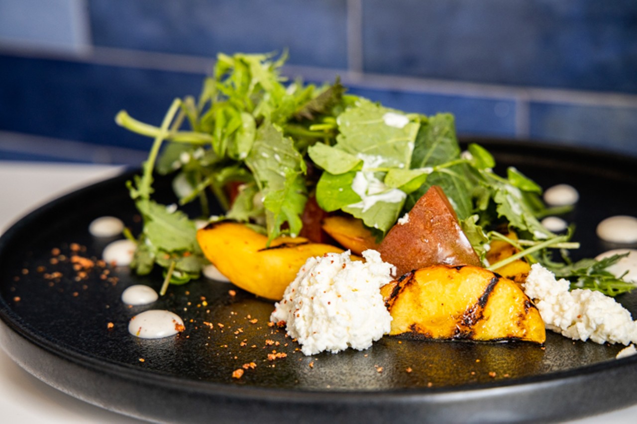 Grilled peach and heirloom tomato salad, with house cottage cheese, local greens and paw paw vinaigrette