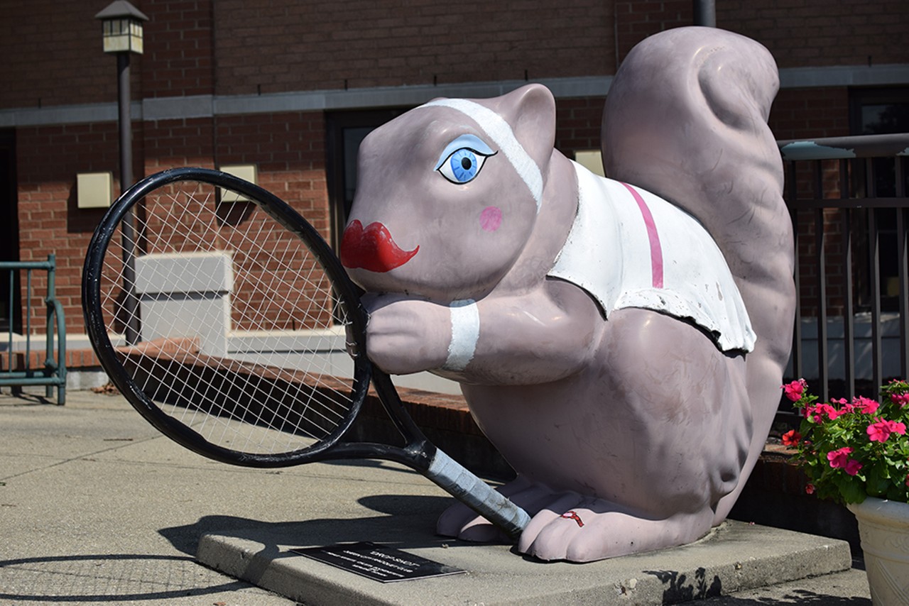The sporty "Drop Shot" squirrel is ready to play outside the Queen City Racquet Club on Chester Road.